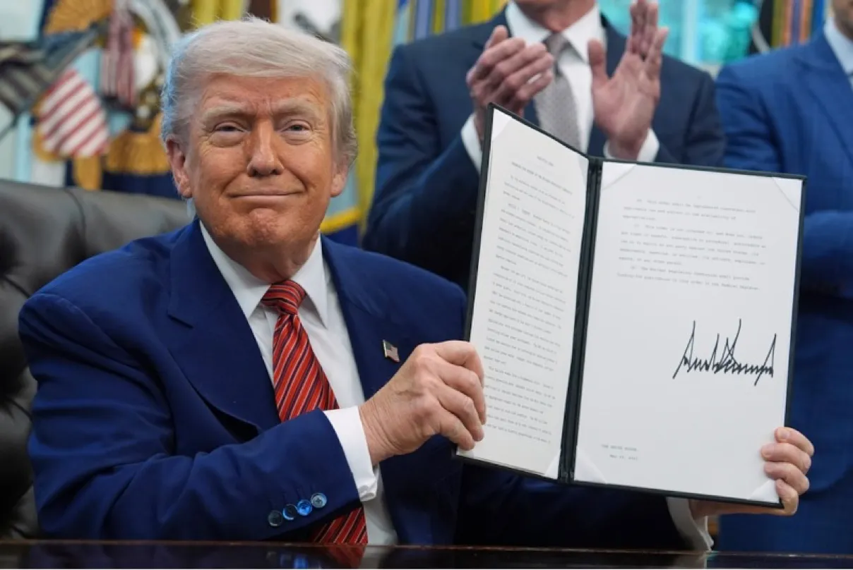 President Trump displays the signed executive order